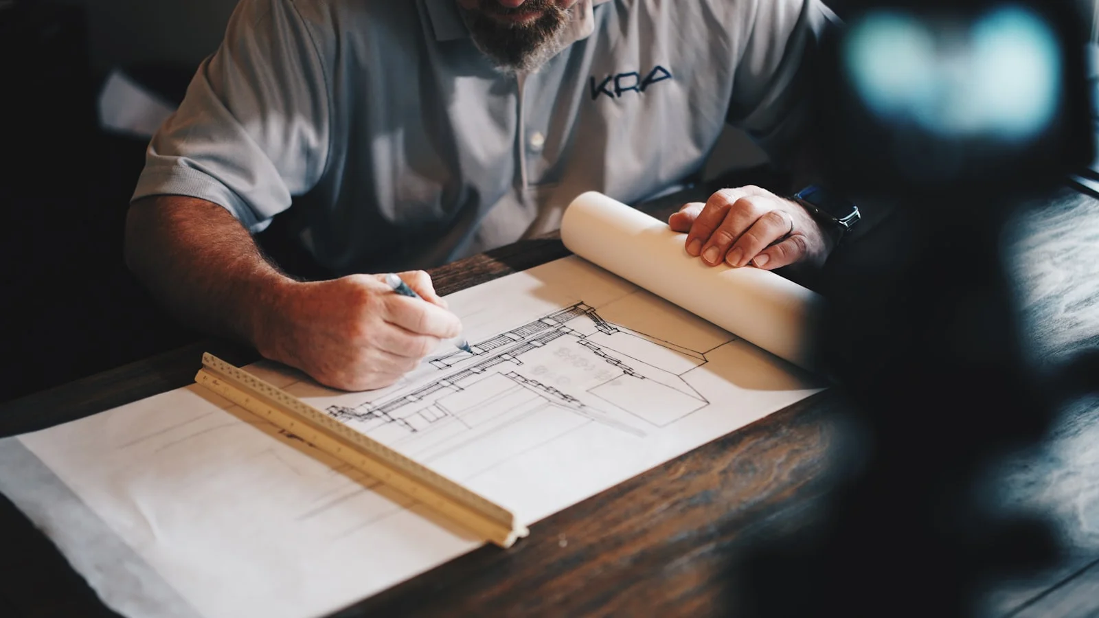 Technical construction drawings being reviewed before site work
