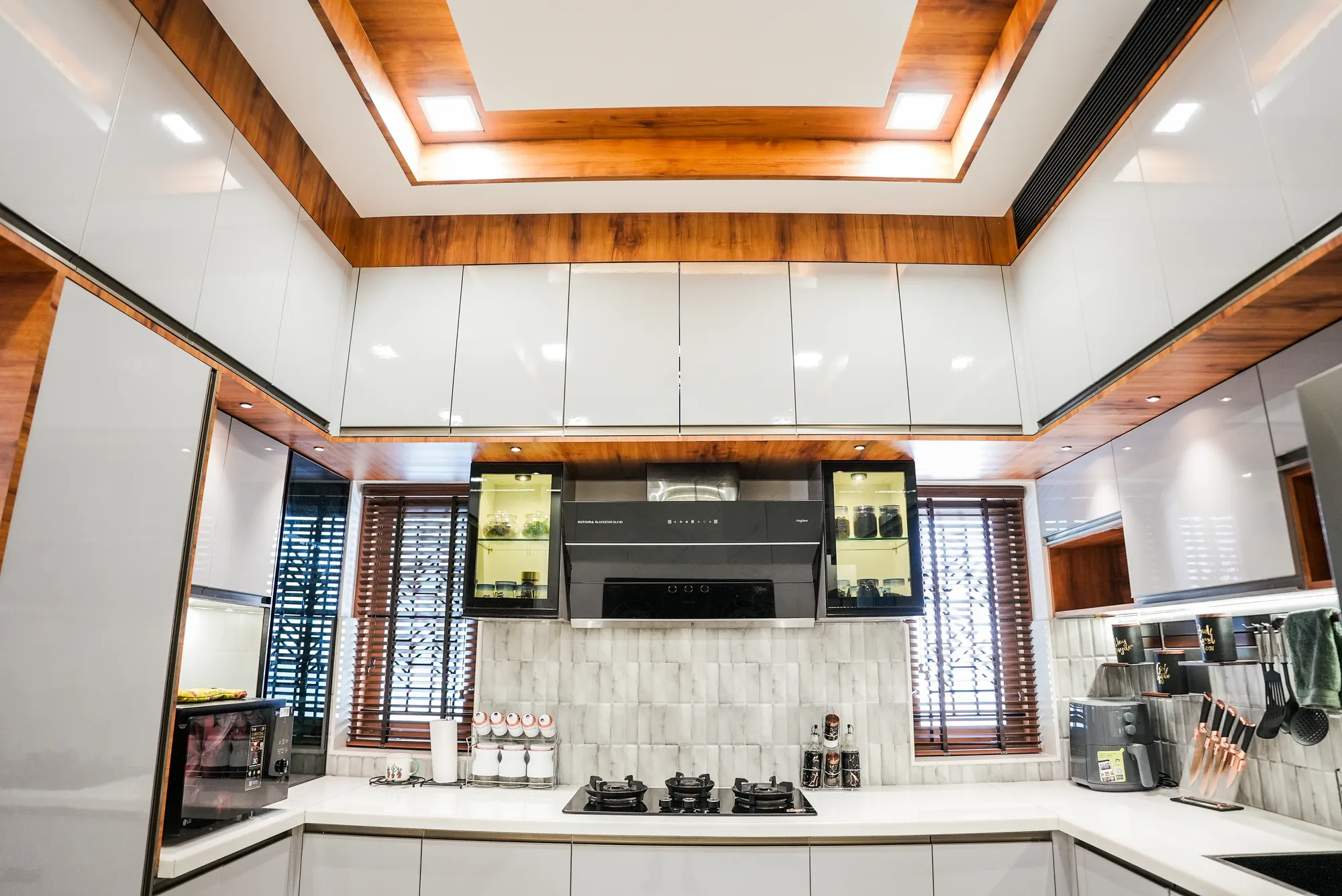 Interior corridor with changing levels and natural light at Sanpra Pranavam