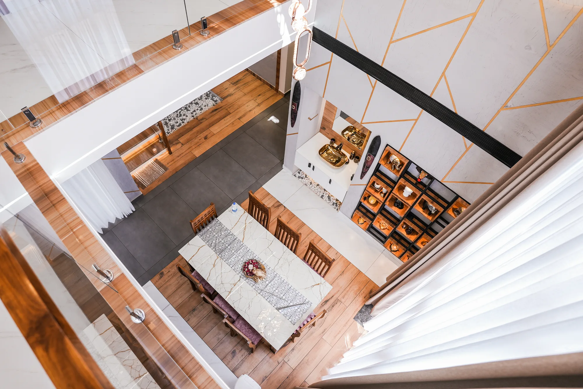 Double-height dining and living connection inside Sanpra Pranavam