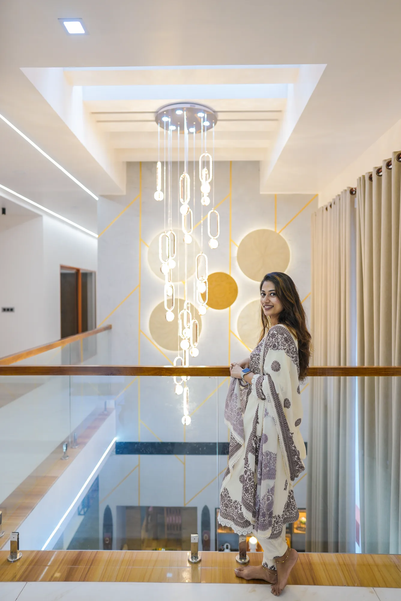Interior view of the double-height space with chandelier at Sanpra Pranavam
