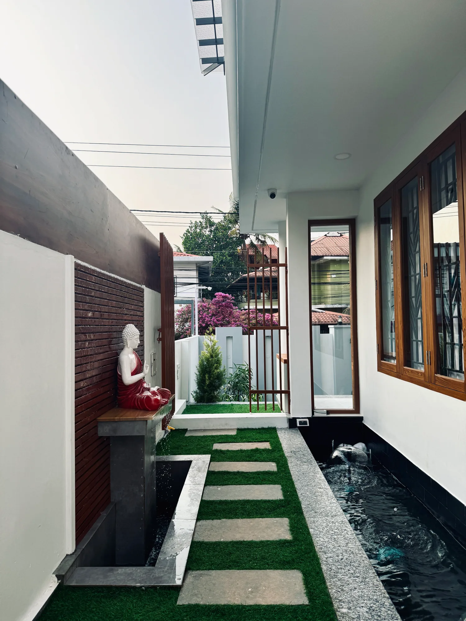 Landscaped patio and water feature at Sanpra Pranavam