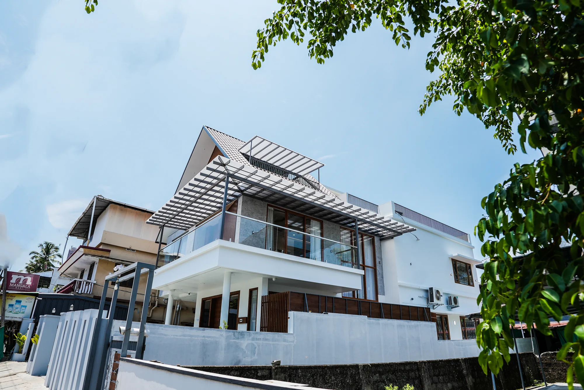 Steel A-frame roof structure and truss geometry at Sanpra Pranavam terrace level