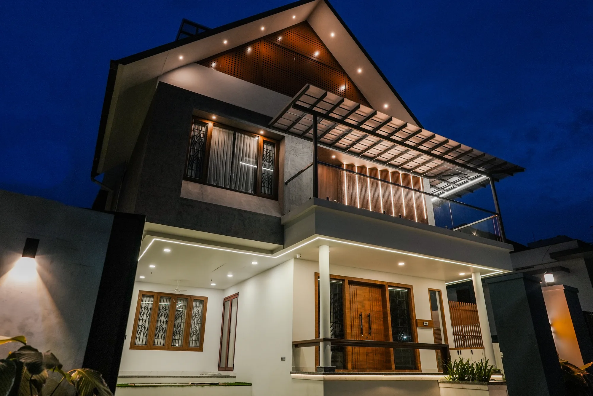 Night exterior of Sanpra Pranavam with architectural lighting in Tripunithura