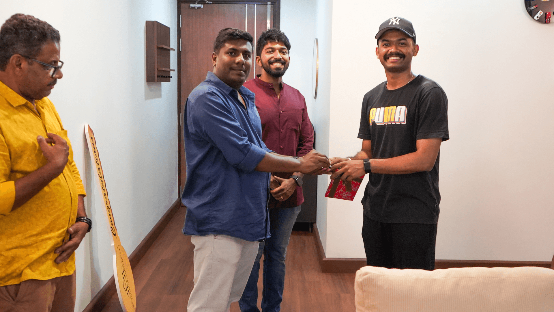 Gift presentation at Mathew Thomas apartment handover