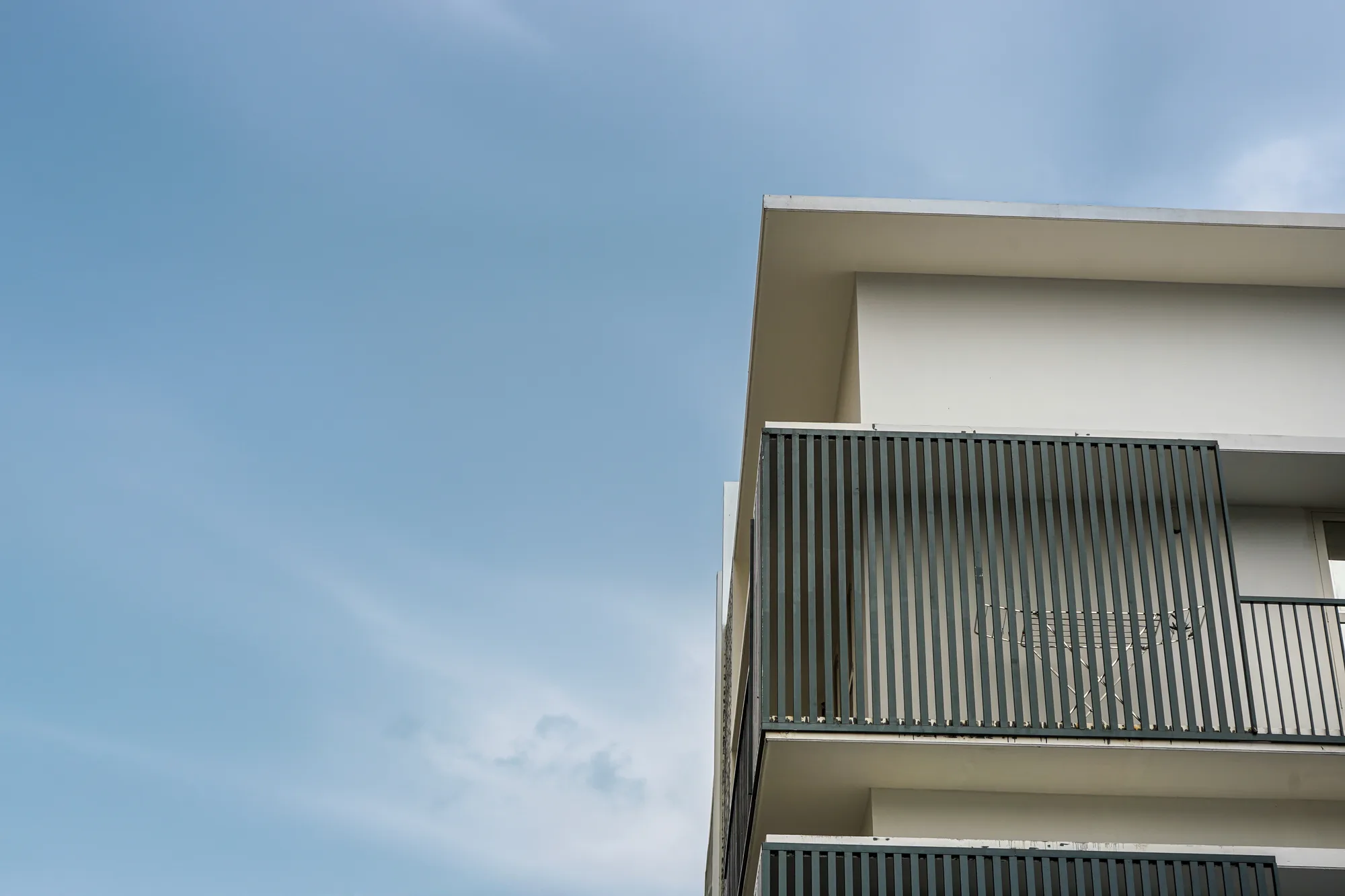 Corner composition of Ratheesh Apartments against the sky