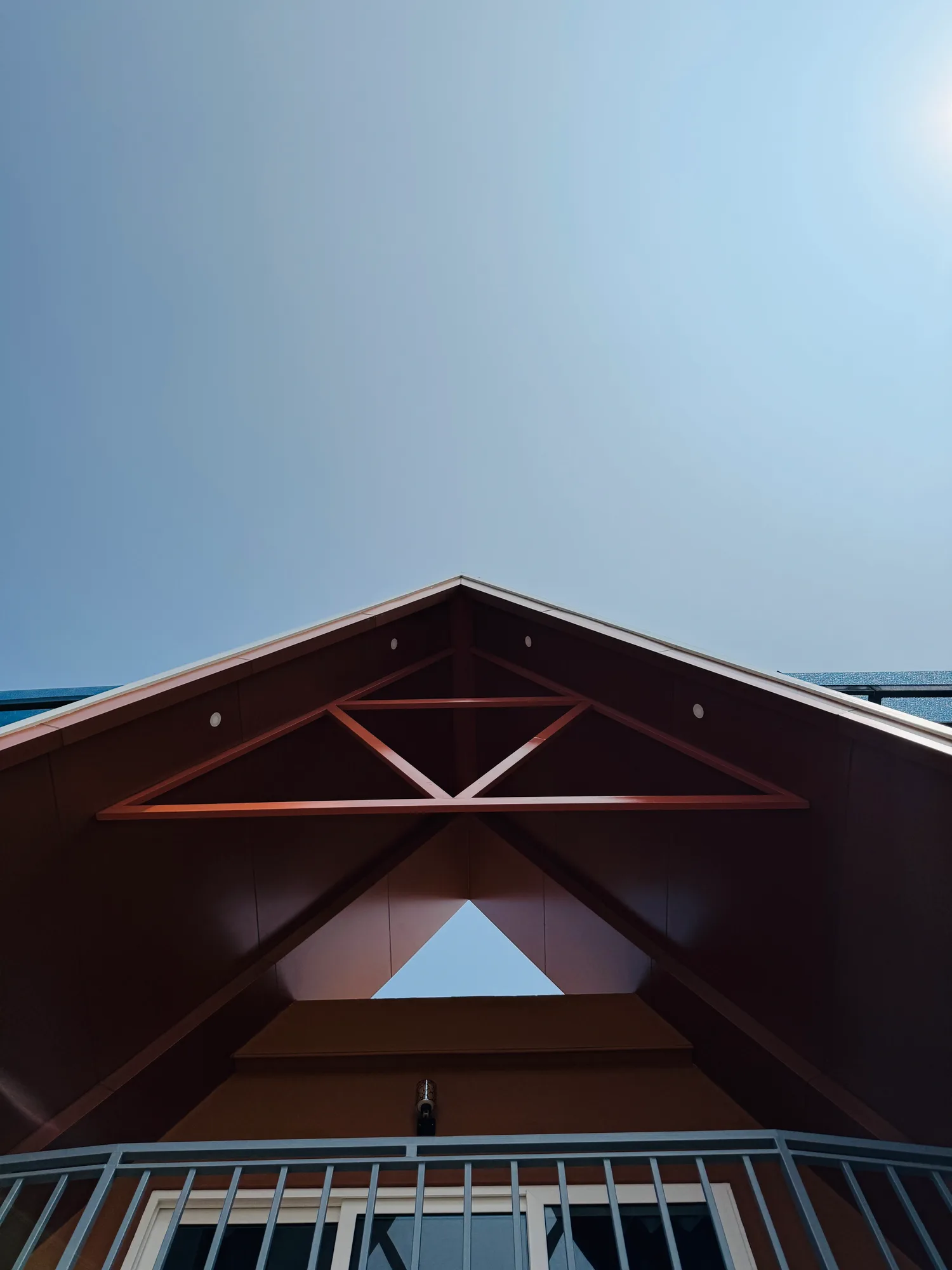 Upward view of triangular roof framing at Sailor Home resort