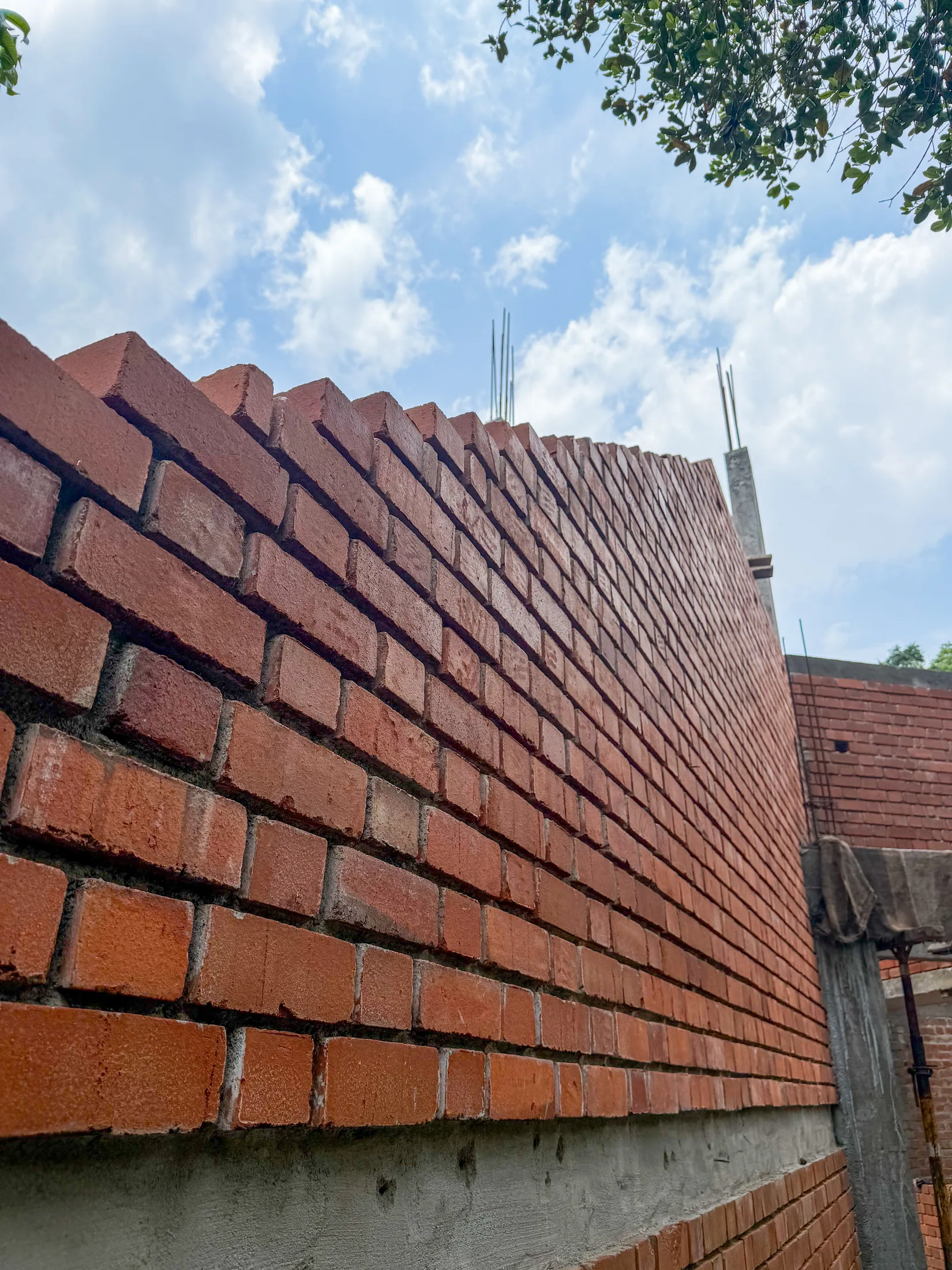 Exposed brick masonry under construction at Vinu and Juline Residence